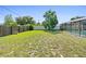 Expansive backyard features lush greenery, offering ample space for outdoor activities and privacy at 2416 Candlewick St, Deltona, FL 32738