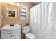 Bathroom featuring updated vanity, mirror, tile, and shower with updated shower curtain at 2416 Candlewick St, Deltona, FL 32738