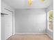 This light and bright bedroom features neutral walls and carpet, a ceiling fan and a closet at 2416 Candlewick St, Deltona, FL 32738
