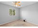 Bedroom with a ceiling fan, carpet flooring and a large window for natural light at 2416 Candlewick St, Deltona, FL 32738