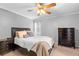 Comfortable bedroom featuring carpet floors, neutral paint, and dark furniture at 2416 Candlewick St, Deltona, FL 32738