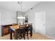 An open dining room with warm tile floors, traditional furnishings, and a chandelier at 2416 Candlewick St, Deltona, FL 32738