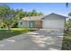 Charming single-Gathering home featuring a two-car garage, brick accents, and a well-manicured lawn at 2416 Candlewick St, Deltona, FL 32738