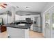 Bright eat-in kitchen featuring white cabinets and black countertops, with stainless steel appliances at 2416 Candlewick St, Deltona, FL 32738