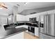 Kitchen with black countertops, stainless steel appliances and an eat-in bar, ready for your personal touch at 2416 Candlewick St, Deltona, FL 32738