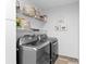 Well-organized laundry room with shelving and newer washer and dryer at 2416 Candlewick St, Deltona, FL 32738
