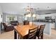 View of living space featuring tile floors, a chandelier, and a kitchen at 2416 Candlewick St, Deltona, FL 32738