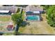 Aerial view of a screened-in pool with a spacious yard and shed, offering privacy and outdoor enjoyment at 2416 Candlewick St, Deltona, FL 32738