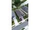 Aerial view displays the home's neutral exterior, well-kept lawn, brick driveway, and desirable neighborhood location at 2435 Pawtucket Pass, Mount Dora, FL 32757