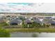 Scenic aerial view of homes in a lakeside community with well-maintained lawns and landscaping at 2435 Pawtucket Pass, Mount Dora, FL 32757