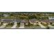 Wide aerial shot showcasing homes in a community surrounding a lake and lush greenery at 2435 Pawtucket Pass, Mount Dora, FL 32757
