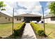 Well-maintained backyard with patio and manicured landscaping at 2435 Pawtucket Pass, Mount Dora, FL 32757