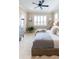 Well-lit bedroom with large windows and stylish decor at 2435 Pawtucket Pass, Mount Dora, FL 32757