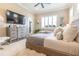 Bright bedroom with elegant furniture and plush bedding at 2435 Pawtucket Pass, Mount Dora, FL 32757