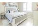 Cozy bedroom featuring coastal-themed décor, a plush bed, tiled floors, and a bright window with shutters at 2435 Pawtucket Pass, Mount Dora, FL 32757