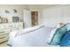Comfortable bedroom featuring light walls, a dresser, tiled floors, and a comfortable bed, creating a relaxing atmosphere at 2435 Pawtucket Pass, Mount Dora, FL 32757