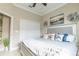 Spacious bedroom featuring a comfortable bed with coastal-themed pillows, tiled floors, a white closet door, and natural light at 2435 Pawtucket Pass, Mount Dora, FL 32757