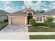 Charming single-Gathering home featuring a two-car garage, landscaped yard, and neutral color palette at 2435 Pawtucket Pass, Mount Dora, FL 32757