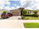 Charming single-story home featuring a well-manicured lawn, a brick driveway, and a two-car garage, perfect for suburban living at 2435 Pawtucket Pass, Mount Dora, FL 32757