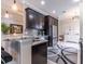 Modern kitchen with dark wood cabinets, granite countertops, and stainless steel appliances at 2435 Pawtucket Pass, Mount Dora, FL 32757