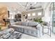 Bright living room with gray sofa, recessed lighting, and open layout to the kitchen at 2435 Pawtucket Pass, Mount Dora, FL 32757