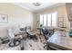 Bright and functional home office with natural light, two desks, comfortable chairs, and a neutral color palette, perfect for productivity at 2435 Pawtucket Pass, Mount Dora, FL 32757
