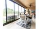 Cozy screened-in patio featuring comfortable seating and a ceiling fan at 2435 Pawtucket Pass, Mount Dora, FL 32757