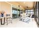 Enclosed patio featuring outdoor dining set and sliding glass doors to the interior at 2435 Pawtucket Pass, Mount Dora, FL 32757
