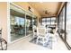 Enclosed patio with comfortable seating, ceiling fan, and beautiful tile flooring at 2435 Pawtucket Pass, Mount Dora, FL 32757