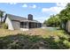 Exterior view of the home showing the screened patio, backyard, and pool at 245 Rosita Dr, Debary, FL 32713
