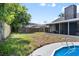 Spacious backyard featuring a swimming pool and screened patio at 245 Rosita Dr, Debary, FL 32713