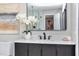 Bathroom showcasing a vanity with white countertop, dark wood cabinets, decorative mirror, and floral arrangement at 245 Rosita Dr, Debary, FL 32713