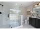 Modern bathroom featuring a glass-enclosed shower with marbled tile and a dark vanity with white countertop at 245 Rosita Dr, Debary, FL 32713