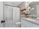 Bathroom with a shower-tub, white granite counter, and modern white wood mirror and cabinets at 245 Rosita Dr, Debary, FL 32713