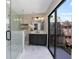 Modern bathroom with glass shower, dark vanity, and access to outdoor space at 245 Rosita Dr, Debary, FL 32713