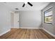 Bedroom featuring wood flooring, a modern ceiling fan, and a large window with a view of the outdoors at 245 Rosita Dr, Debary, FL 32713