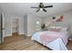 Light bedroom with light walls and accents, wood floors, and a closet at 245 Rosita Dr, Debary, FL 32713