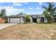 Charming single-story home with a well-manicured lawn, a two-car garage, and lovely landscaping at 245 Rosita Dr, Debary, FL 32713