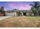 Charming single-story home with a well-manicured lawn, a two-car garage, and lovely landscaping at 245 Rosita Dr, Debary, FL 32713