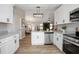 Open kitchen with white cabinets, stainless steel appliances, granite countertops, and wood floors at 245 Rosita Dr, Debary, FL 32713