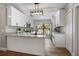 Bright kitchen with white cabinets, granite countertops, stainless appliances, and a large window at 245 Rosita Dr, Debary, FL 32713