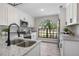 Bright kitchen featuring stainless appliances, granite countertops, white cabinetry and a large window at 245 Rosita Dr, Debary, FL 32713