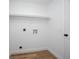 Laundry room featuring white walls, trim and door, with wood look floors and shelving at 245 Rosita Dr, Debary, FL 32713