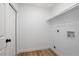 Laundry room featuring white walls, trim and door, with wood look floors and shelving at 245 Rosita Dr, Debary, FL 32713