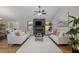 Cozy living room featuring a fireplace, vaulted ceilings, and hardwood flooring at 245 Rosita Dr, Debary, FL 32713