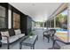 Covered patio featuring wicker furniture and glass table overlooking the backyard swimming pool at 245 Rosita Dr, Debary, FL 32713