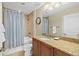 Neutral bathroom with granite vanity, shower over tub and blue striped curtain at 2515 S Atlantic Ave # 1001, Daytona Beach Shores, FL 32118