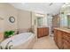 Elegant bathroom with a soaking tub, granite counters, and a glass block shower at 2515 S Atlantic Ave # 1001, Daytona Beach Shores, FL 32118