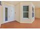 Building entrance with neutral tone paint, tile flooring, and security door at 2515 S Atlantic Ave # 1001, Daytona Beach Shores, FL 32118
