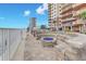 Inviting beachside firepit at condo complex, with lovely blue glass and stone construction, offering serene outdoor gathering space at 2515 S Atlantic Ave # 1001, Daytona Beach Shores, FL 32118